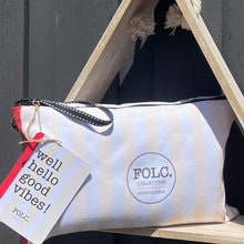 Load image into Gallery viewer, The Aussie Rug sand-free beach towel packed inside its reusable travel pouch.
