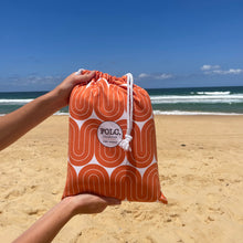 Load image into Gallery viewer, The Desert XXL sand-free beach towel packed inside its compact travel pouch.
