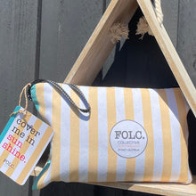 Load image into Gallery viewer, The Reef sand-free beach towel packed inside its reusable travel pouch.
